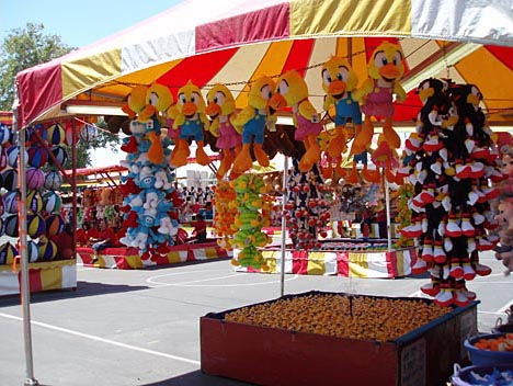 Plush prizes hang in a midway game booth