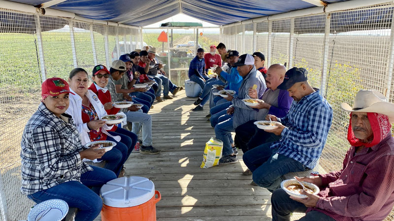 photo: farmworkers eating a meal